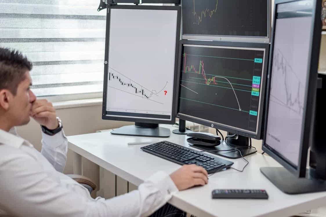 analysts reviewing financial data on computer